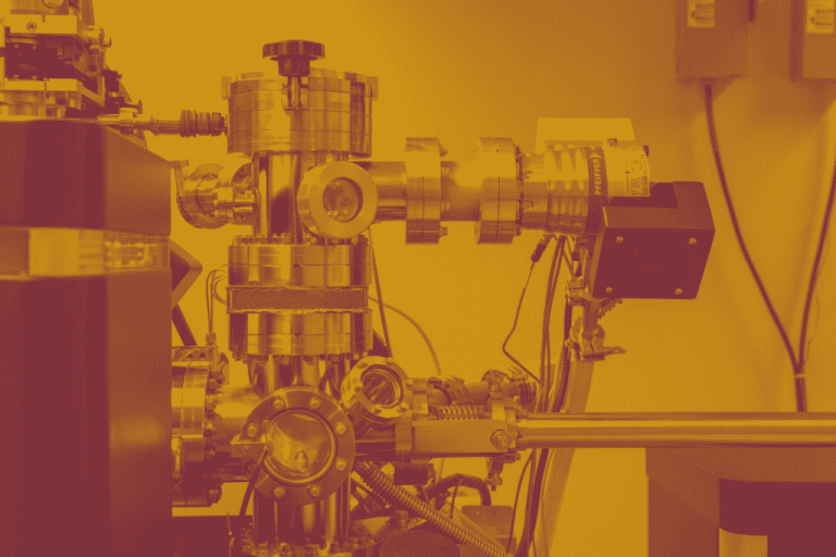A maroon yellow duotone image of a machine in a lab