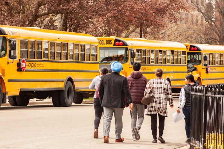 School buses on campus transporting students and parents visiting campus