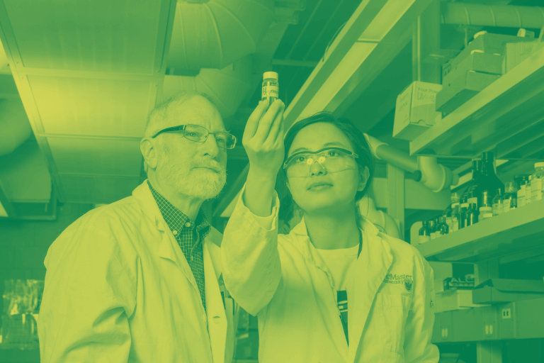 A green-yellow duotone image of a man and a woman standing in a lab, examining a vial