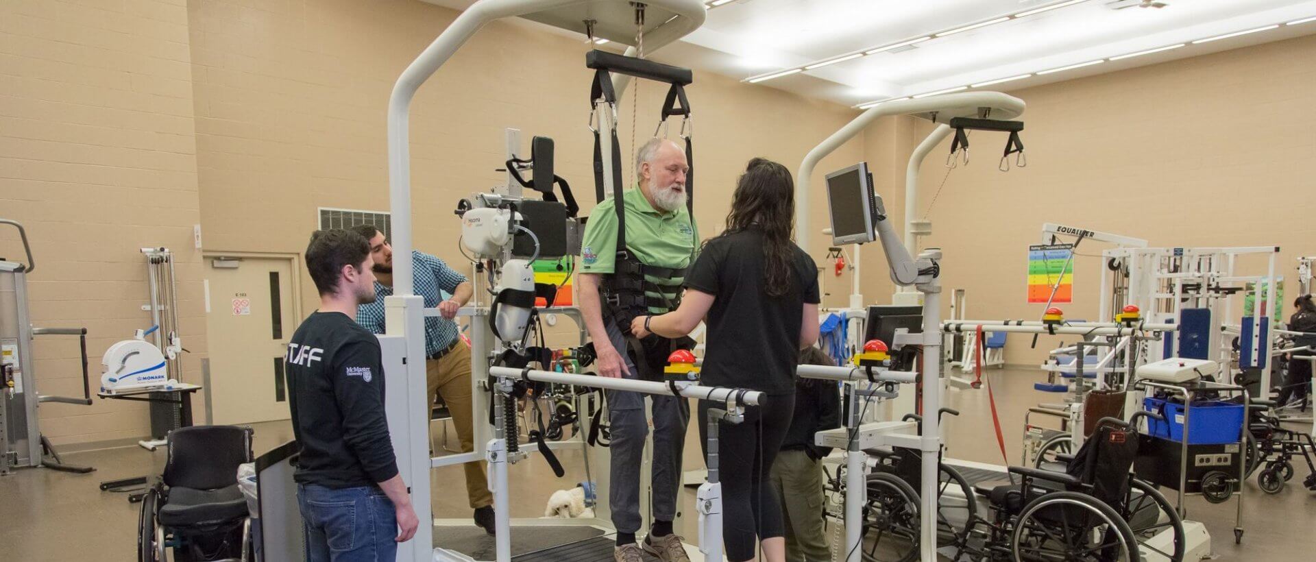 Kinesiology team members working with a man in a rehabilitation facility