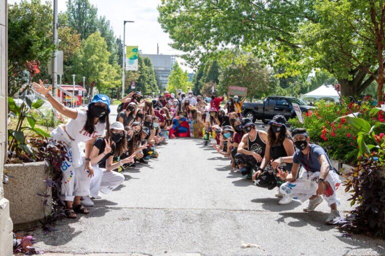 Students at welcome week looking at the camera and welcoming students