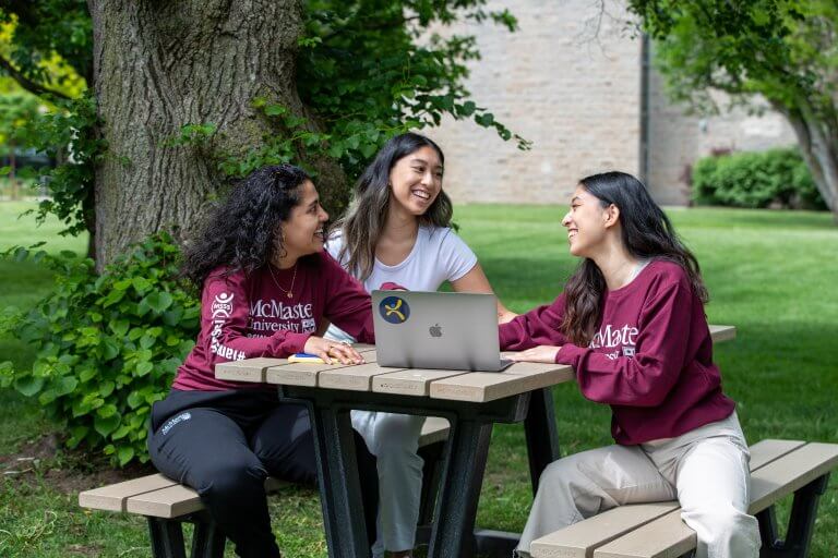 A group of students sitting around chatting at the McMaster campus
